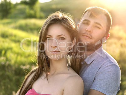 Outdoor summer portrait of pretty nice young family couple in lo