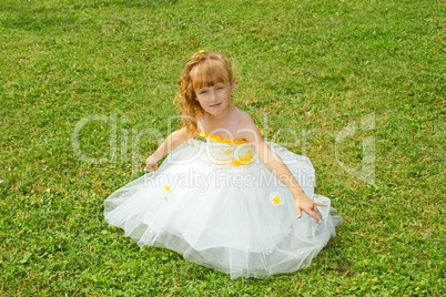 Girl in a festive dress on a lawn