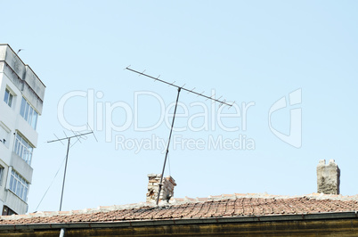 Orange Roof Tiles, Chimney And Old Analog Tv Antenna
