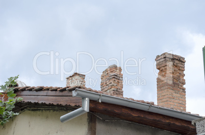 Tile Roof With Brick Chimneys