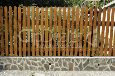 fence of wooden slats on the stones