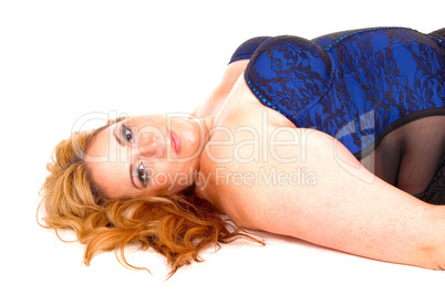 Blond woman lying in corset.