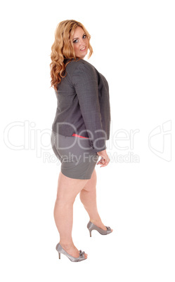 Plus size woman standing in shorts.