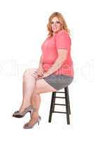Young plus size woman sitting.