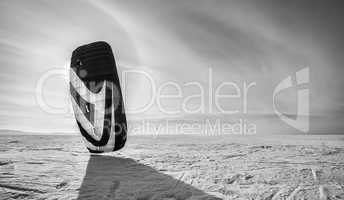 Kiteboarder with blue kite on the snow