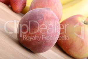 fruits on wooden table, peach, apple, bananas, food concept