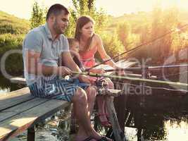 Young family fishing holiday with wooden planked footway