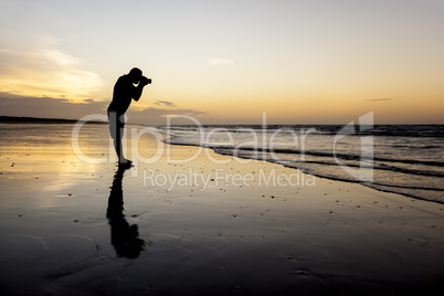 photographer at the sunset beach