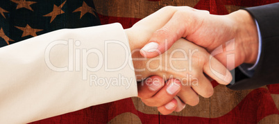 Composite image of close up on partners shaking hands