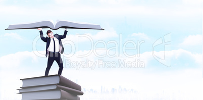 Composite image of businessman in suit lifting up something heav