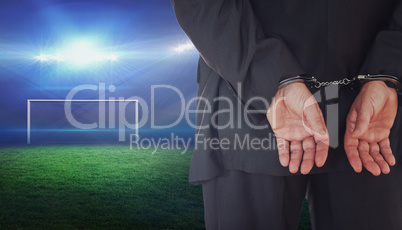 Composite image of businessman in handcuffs