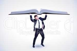 Composite image of businessman in suit lifting up something heav