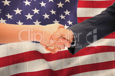 Composite image of close up of a handshake