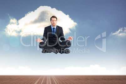 Composite image of calm businessman sitting in lotus pose