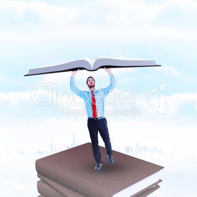 Composite image of businessman in suit pushing up with effort