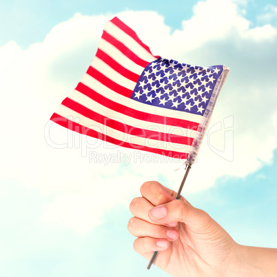 Composite image of hand waving american flag