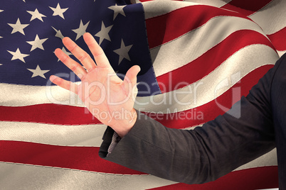 Composite image of businessman holding hand out in presentation