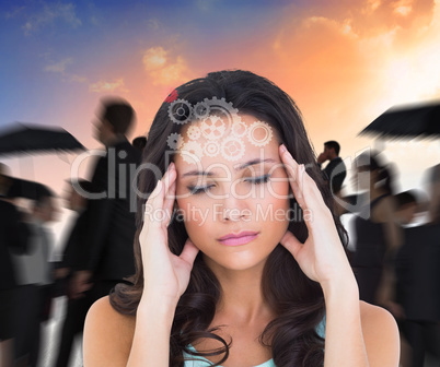 Composite image of pretty brunette with a headache