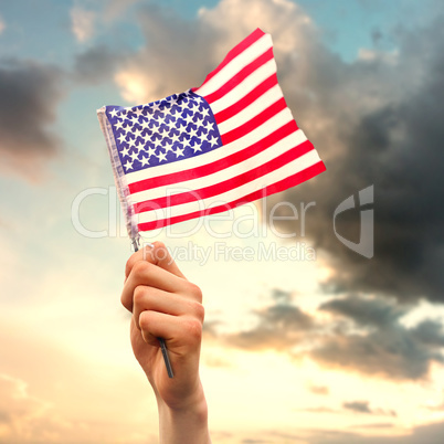 Composite image of hand waving american flag