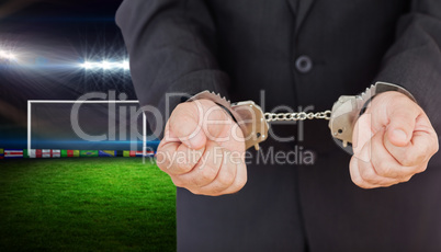 Composite image of handcuffed businessman