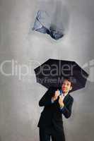 Composite image of businessman sheltering with black umbrella