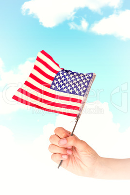 Composite image of hand waving american flag