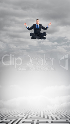 Composite image of calm businessman sitting in lotus pose