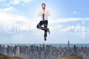 Composite image of smiling businessman standing in tree pose