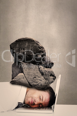 Composite image of tired businessman resting on laptop