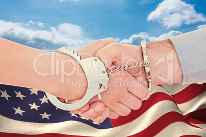 Composite image of handcuffed business people shaking hands