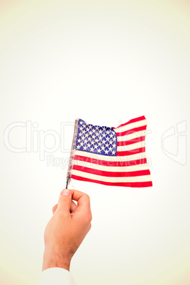 Composite image of hand waving american flag