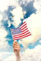 Composite image of hand waving american flag