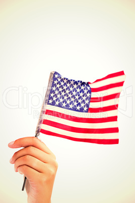 Composite image of hand waving american flag