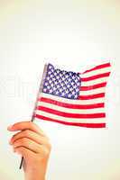 Composite image of hand waving american flag