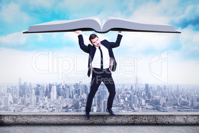 Composite image of businessman in suit lifting up something heav