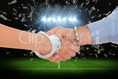 Composite image of handcuffed business people shaking hands