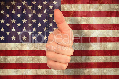 Composite image of hand showing thumbs up