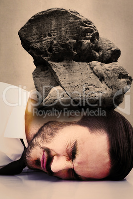 Composite image of businessman banging his head