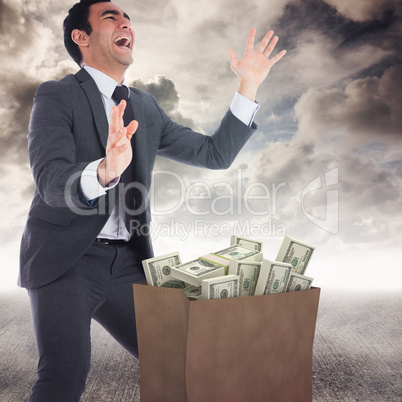 Composite image of excited businessman catching