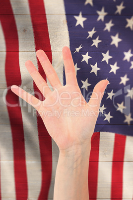 Composite image of woman showing her hand