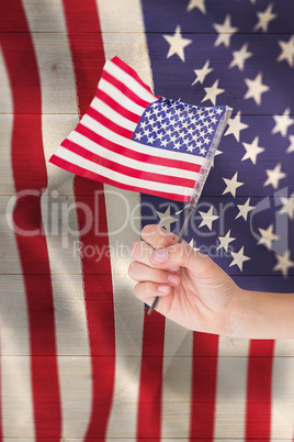 Composite image of hand waving american flag