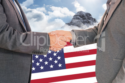 Composite image of close up on two businesspeople shaking hands