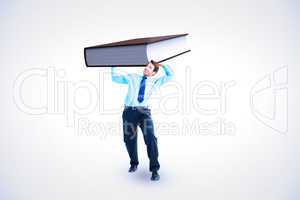 Composite image of focused businessman lifting up something heav