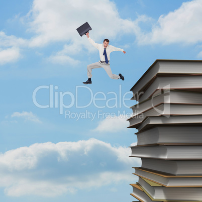 Composite image of cheerful jumping businessman with his suitcas