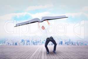 Composite image of businessman bending and pushing