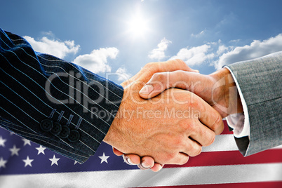 Composite image of business people shaking hands