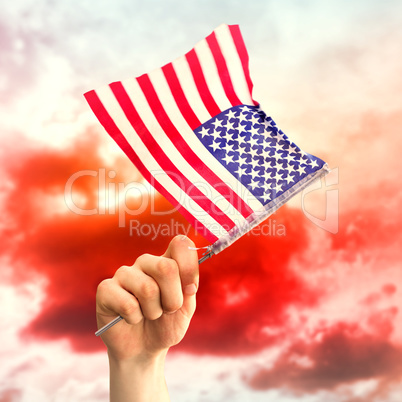 Composite image of hand waving american flag