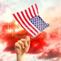 Composite image of hand waving american flag