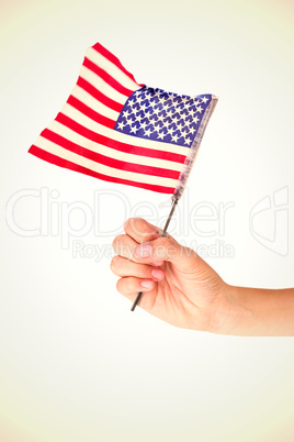 Composite image of hand waving american flag