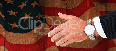 Composite image of businessman in suit clenching fists